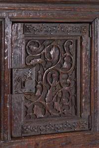 A Gothic Revival Carved Oak Cabinet on Stand