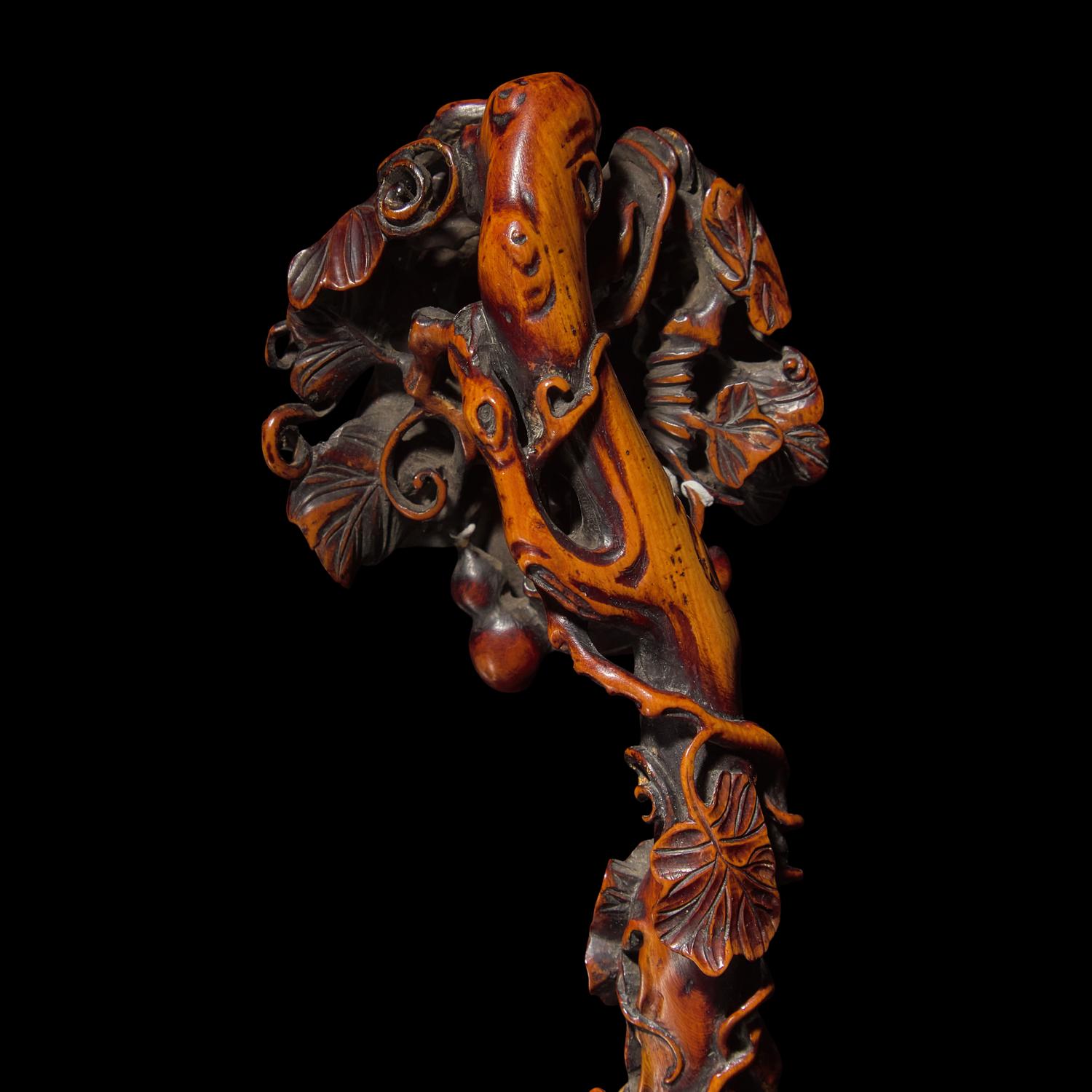 A Chinese Finely Carved Stained Bone Ruyi Scepter, Qing Dynasty — 清 木“福祿萬代”如意