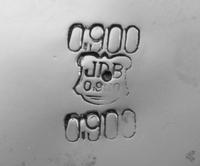 A Silver Water Pitcher, Maker's Mark JDB, having a baluster form body with an S-scroll and foliate decorated rim, raised on foliate fee