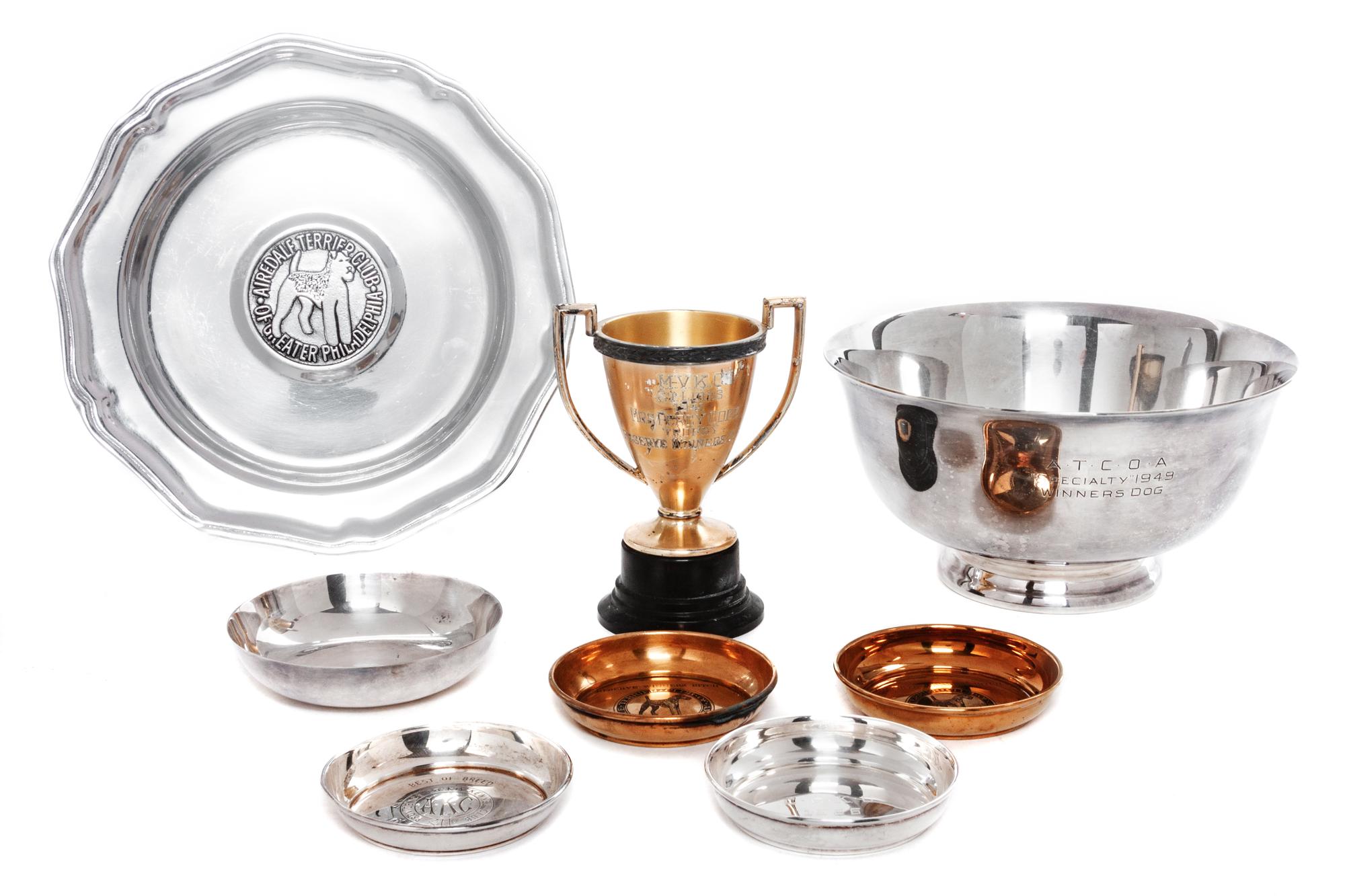 A Group of Eight Silverplate and Pewter Articles related to Airedale Terriers Width of widest 9 1/8 inches.