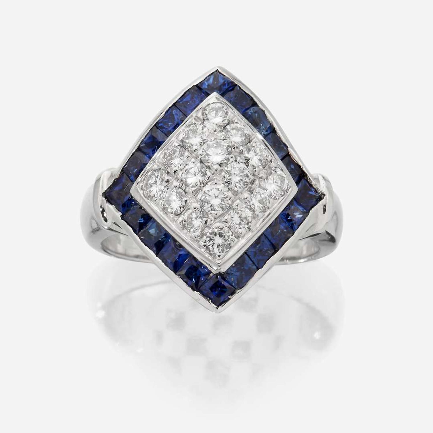 An eighteen karat white gold, diamond, and sapphire ring