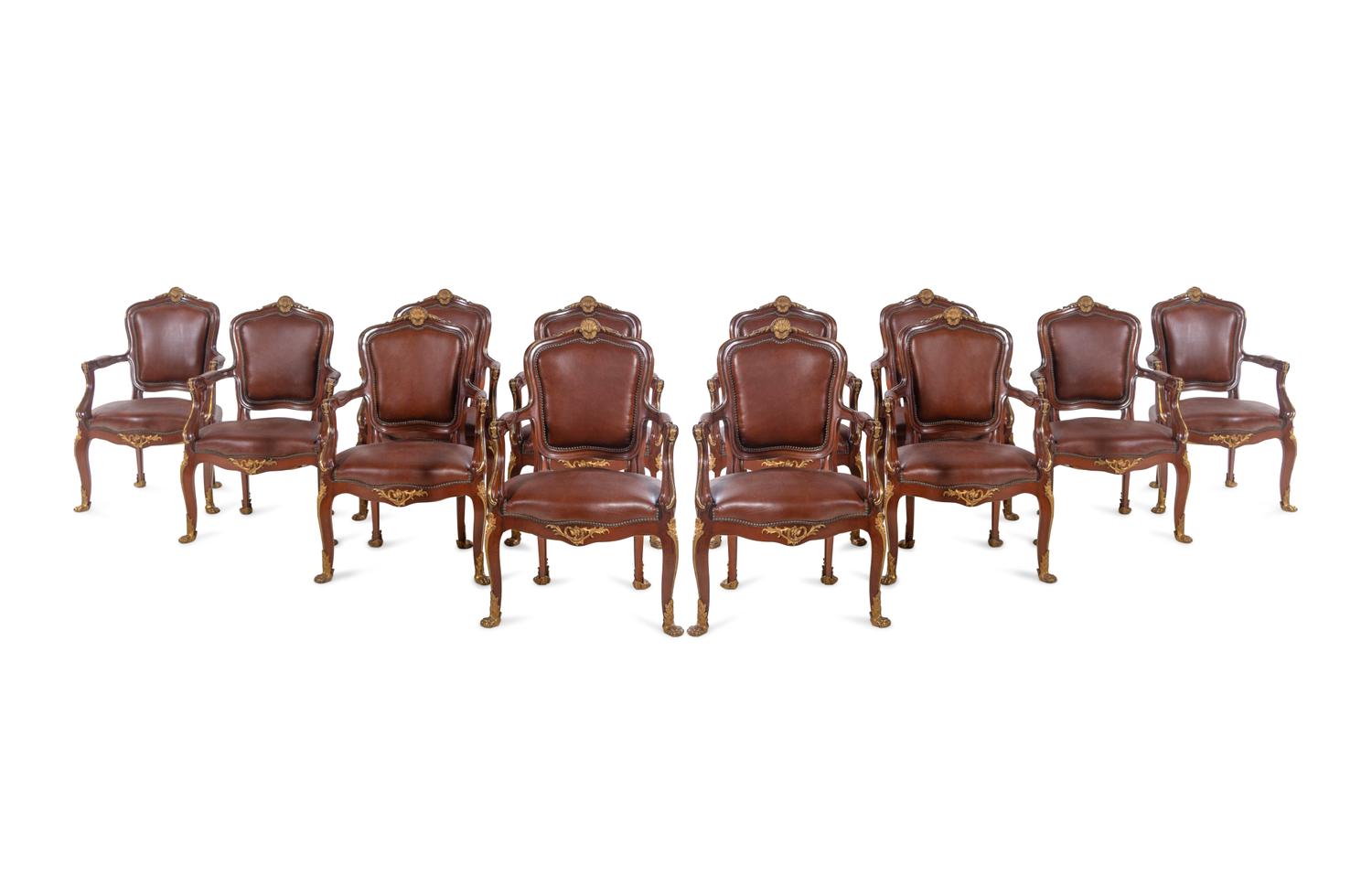 A Set of Fourteen Louis XV Style Gilt Bronze Mounted Walnut Dining Chairs