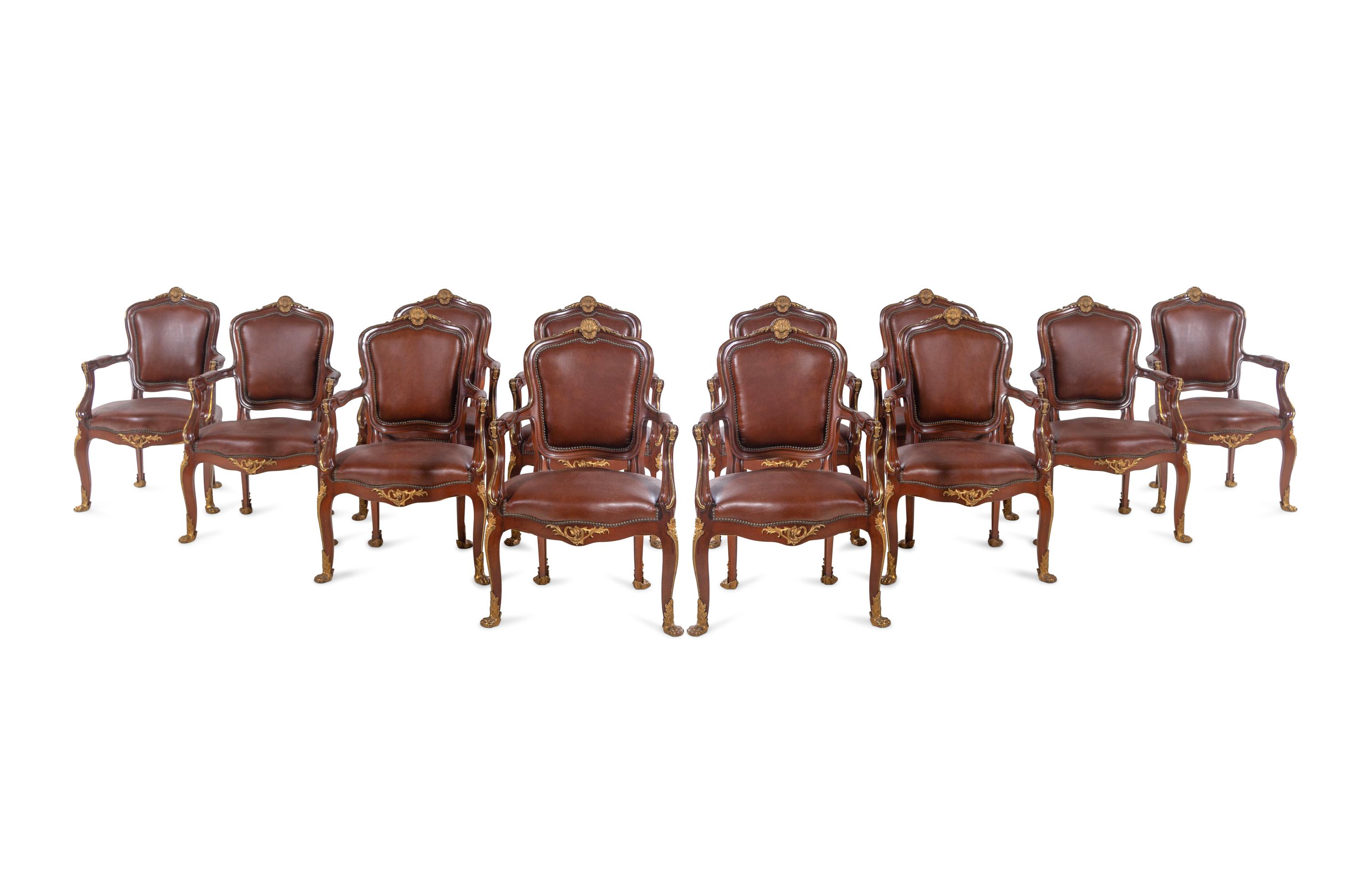 A Set of Fourteen Louis XV Style Gilt Bronze Mounted Walnut Dining Chairs