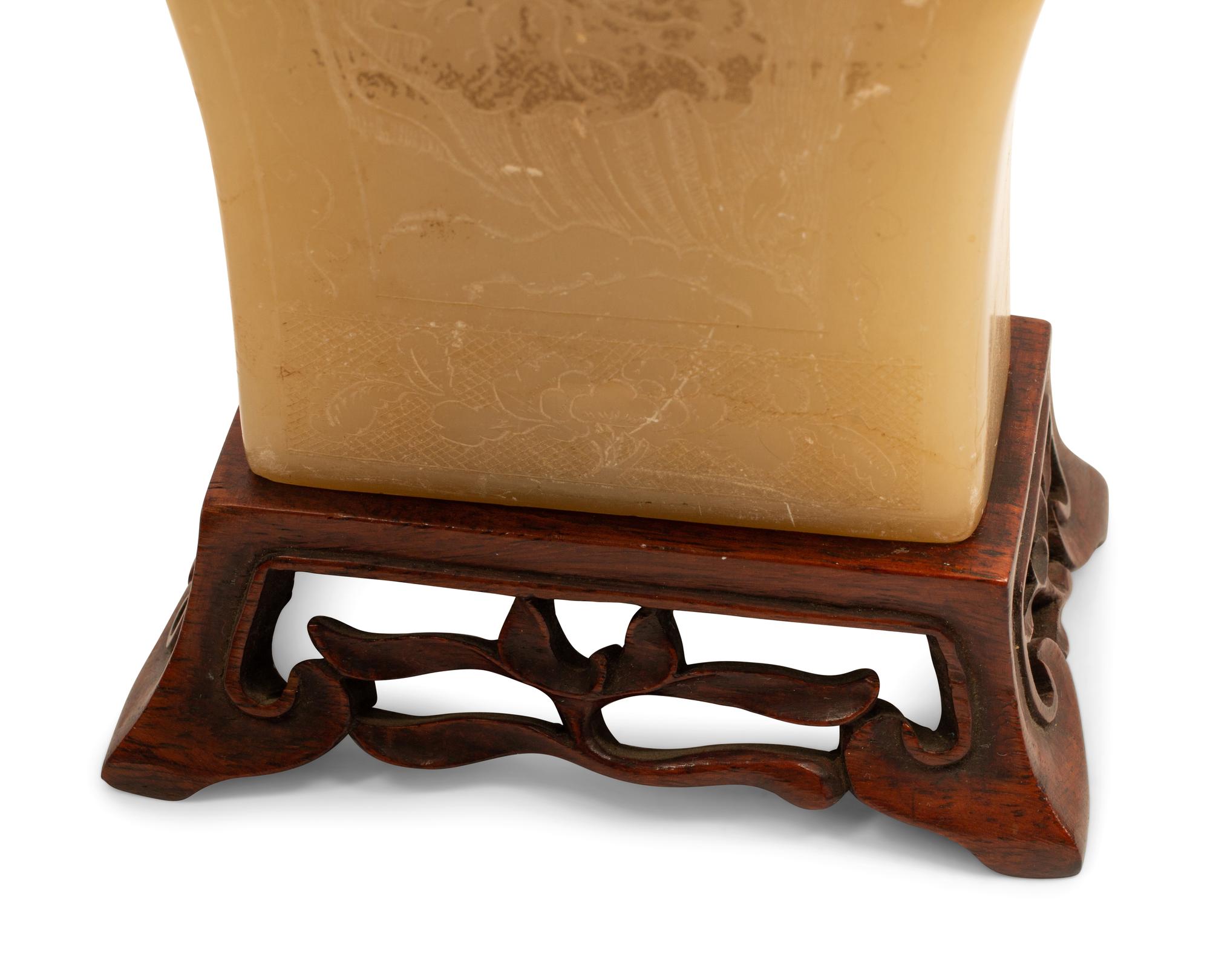 A Pair of Chinese Carved White Stone Jars on Wood Bases