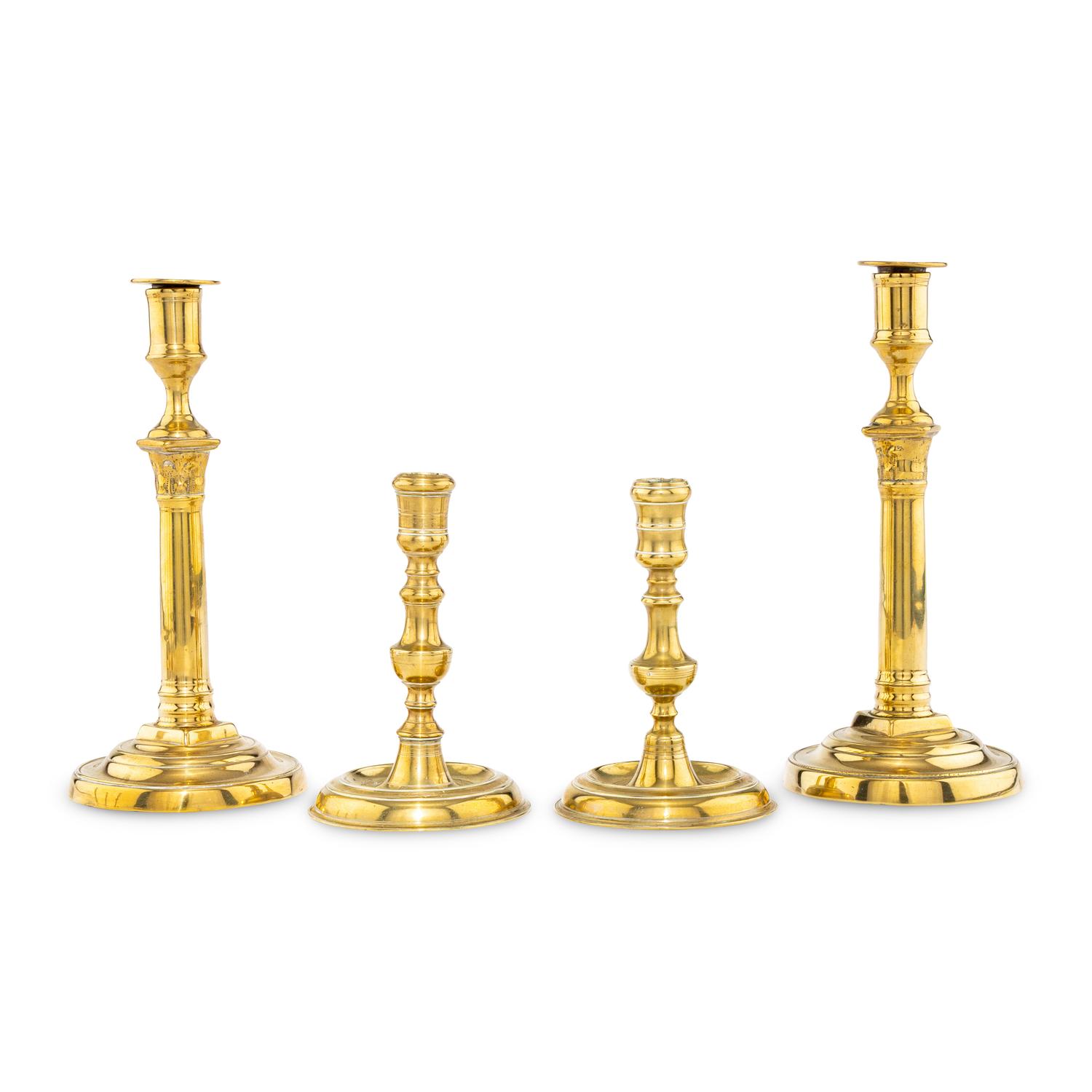 A Collection of Two Pairs of Brass Candlesticks