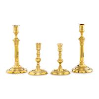 A Collection of Two Pairs of Brass Candlesticks