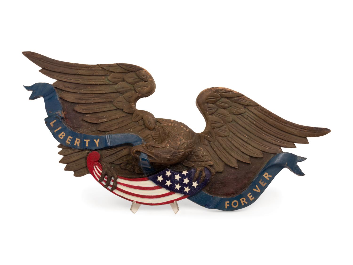 A Carved and Painted Eagle and a Carved, Painted and Parcel Gilt Eagle Plaque