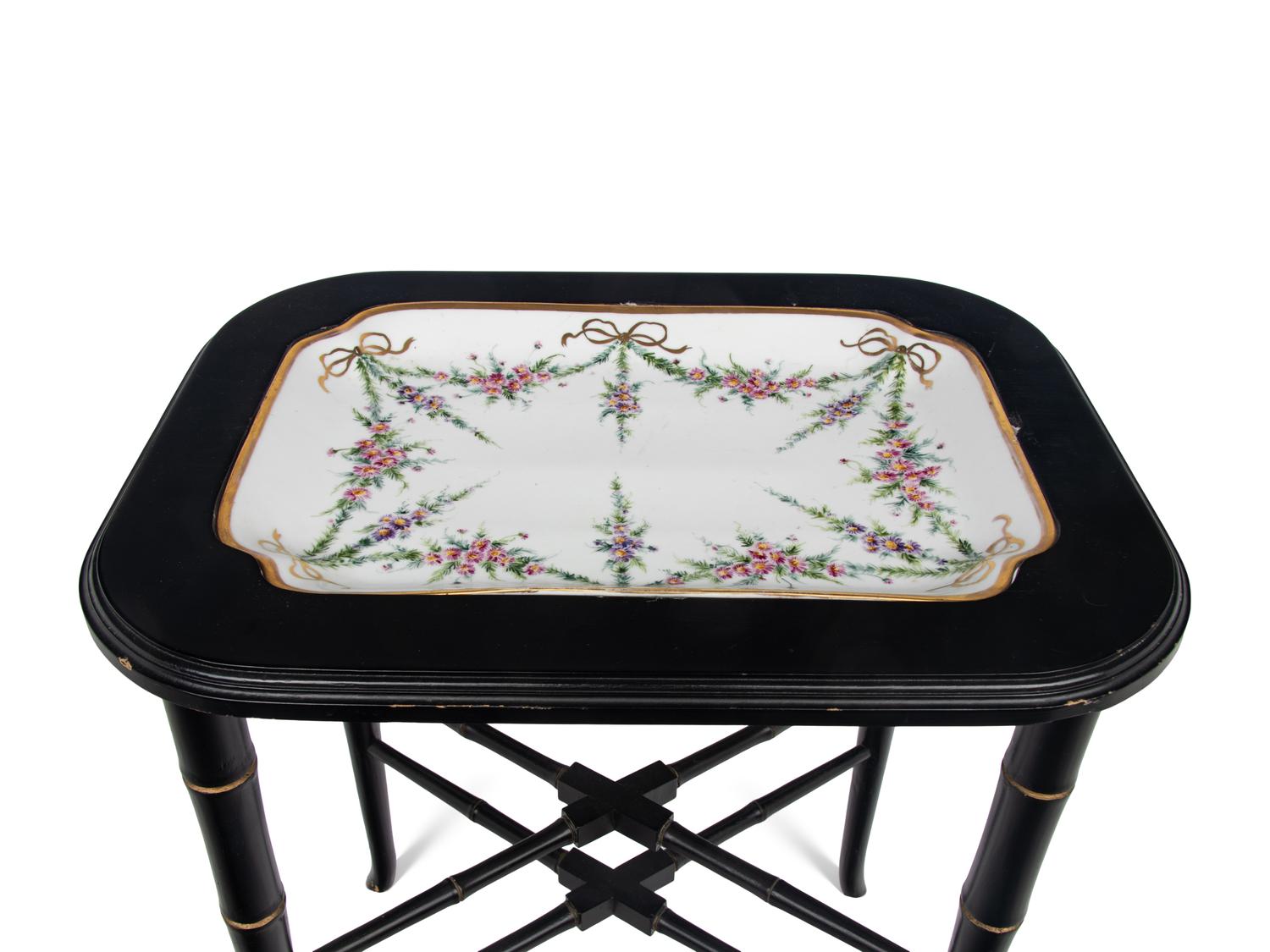 A German Porcelain Tray Set in a Later Ebonized Side Table