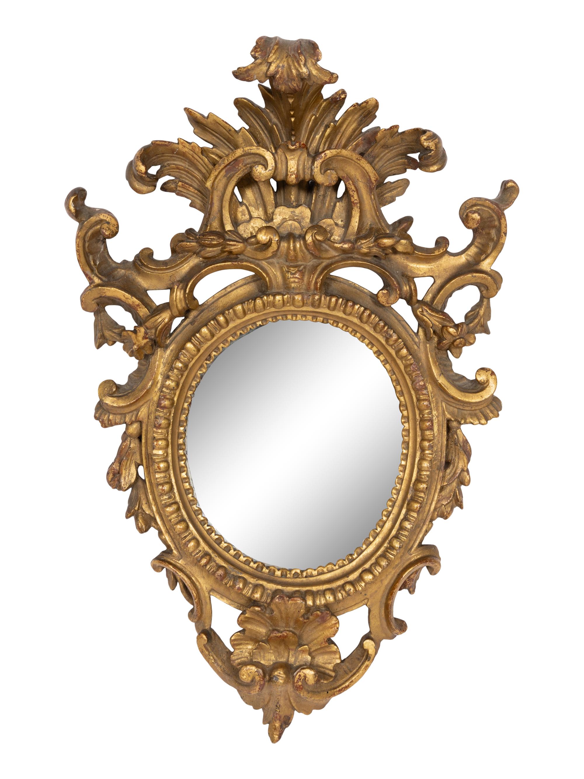 A Pair of Italian Baroque Oval Giltwood Mirrors