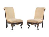 A Pair of Anglo-Colonial Carved and Parcel Gilt Slipper Chairs