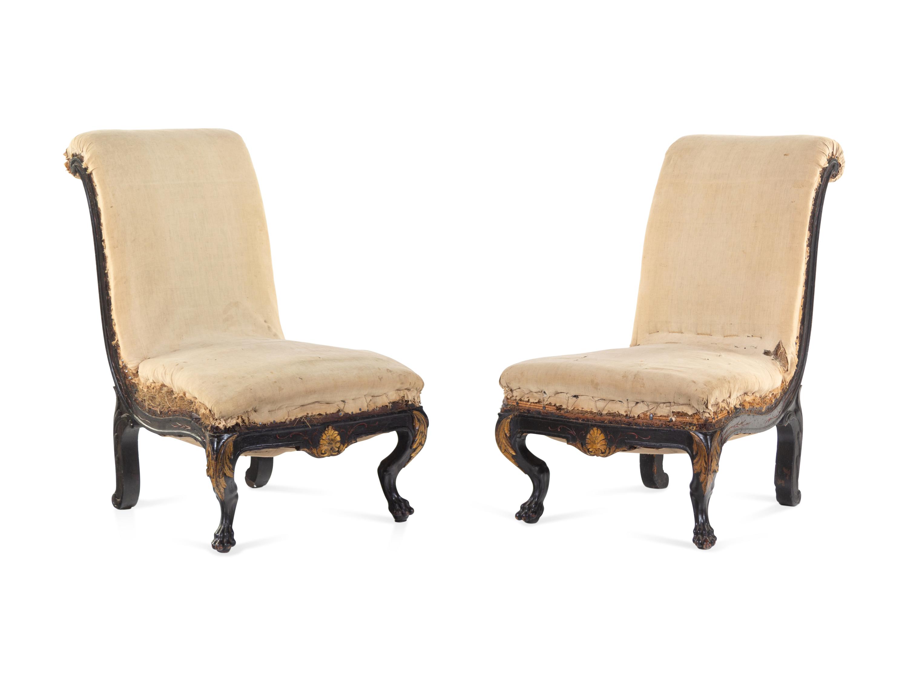 A Pair of Anglo-Colonial Carved and Parcel Gilt Slipper Chairs