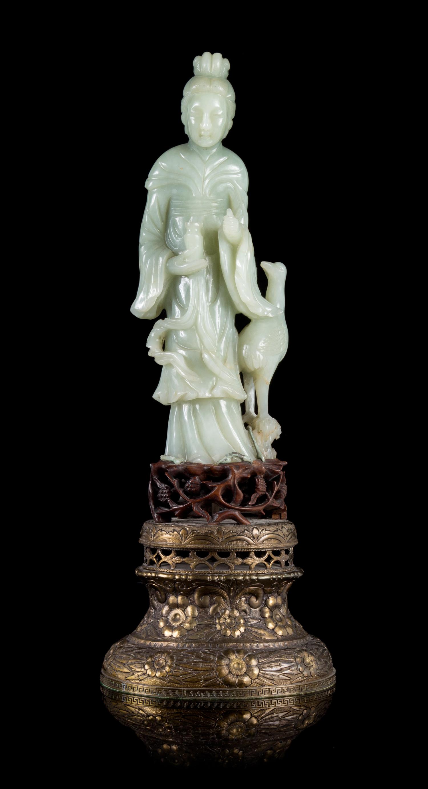 A Celadon Jade Figure of Guanyin Height of figure 9 3/4 inches. — 19TH/20TH CENTURY