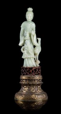 A Celadon Jade Figure of Guanyin Height of figure 9 3/4 inches. — 19TH/20TH CENTURY