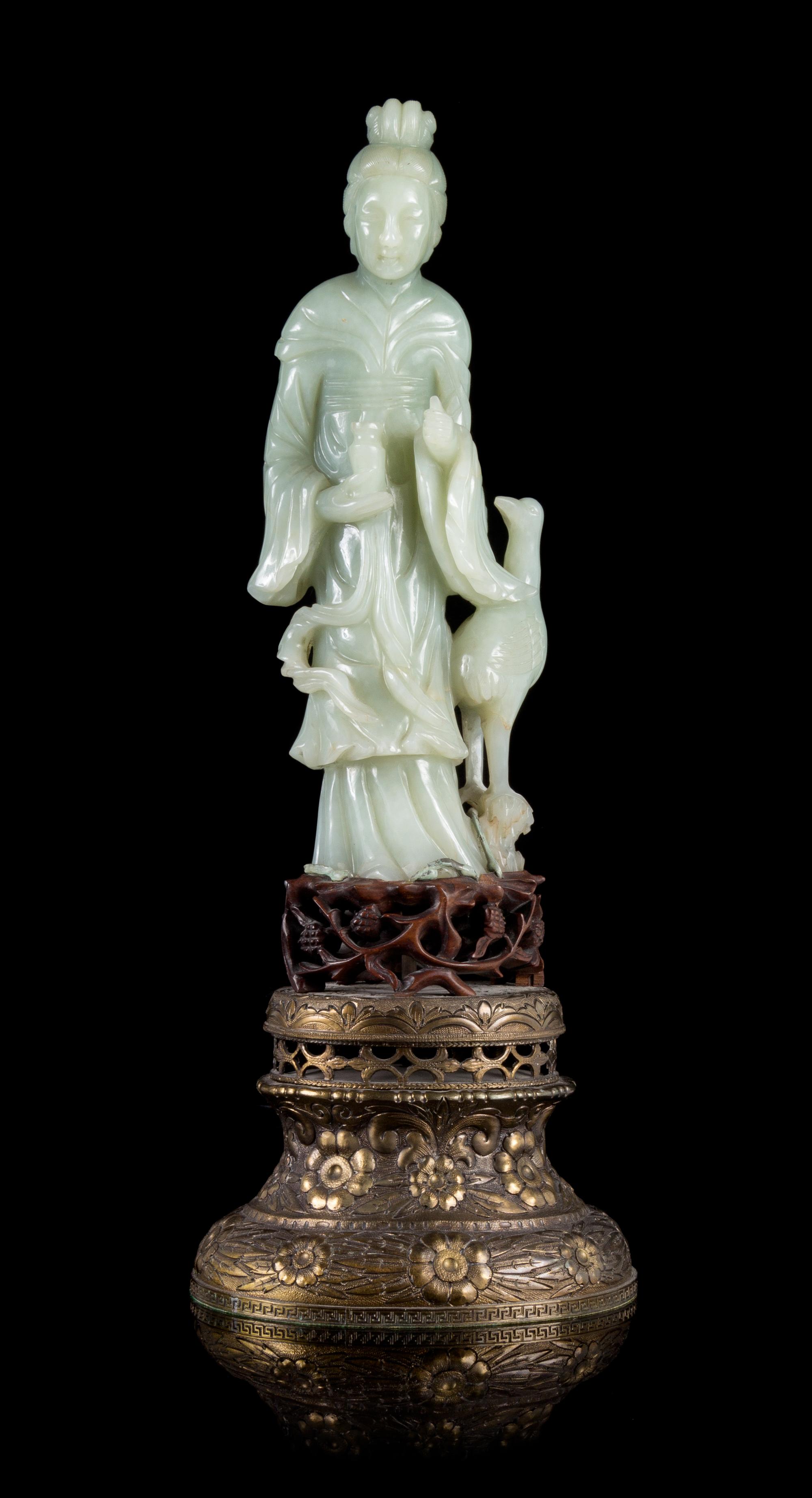 A Celadon Jade Figure of Guanyin Height of figure 9 3/4 inches. — 19TH/20TH CENTURY