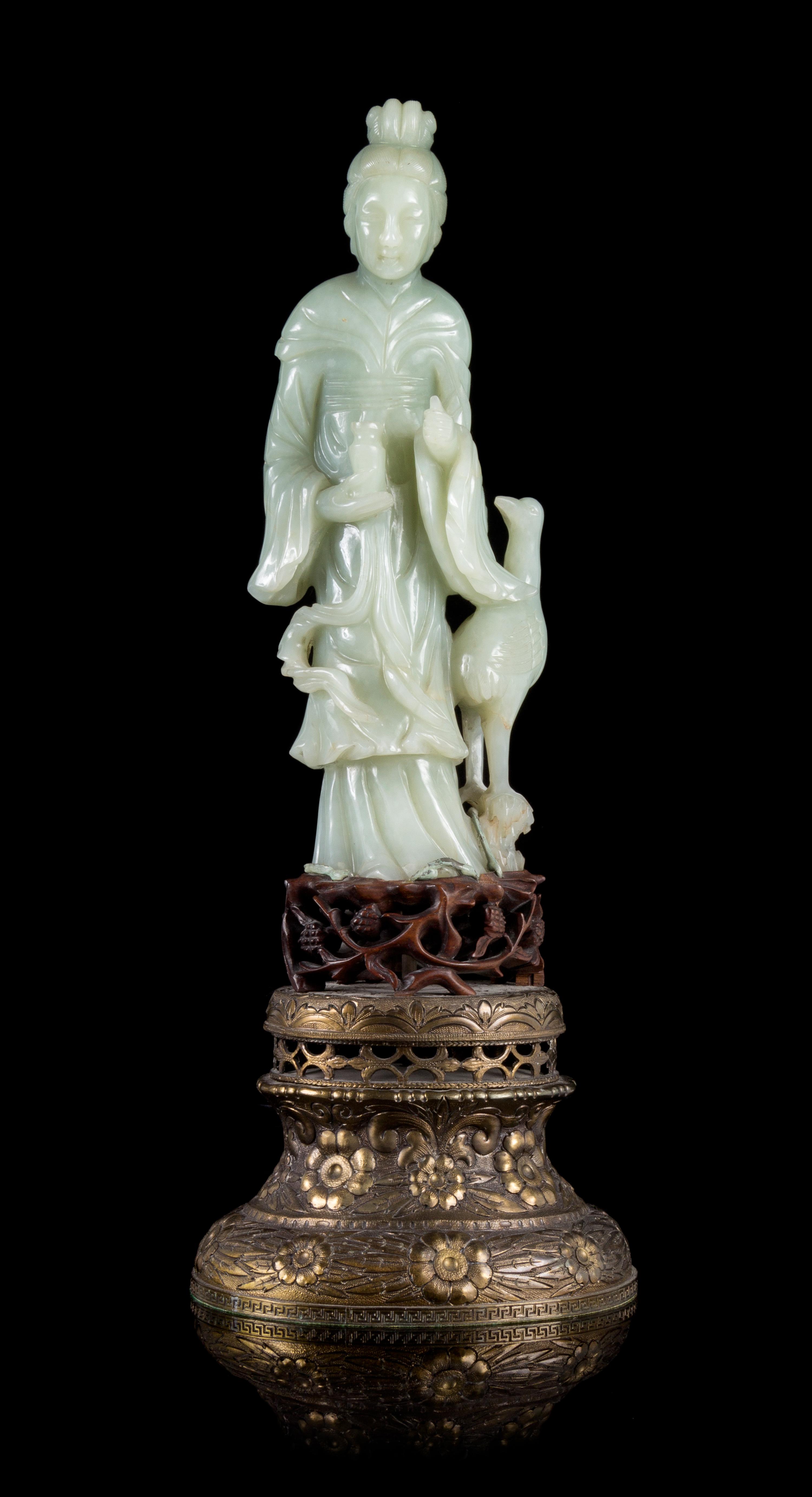 A Celadon Jade Figure of Guanyin Height of figure 9 3/4 inches. — 19TH/20TH CENTURY