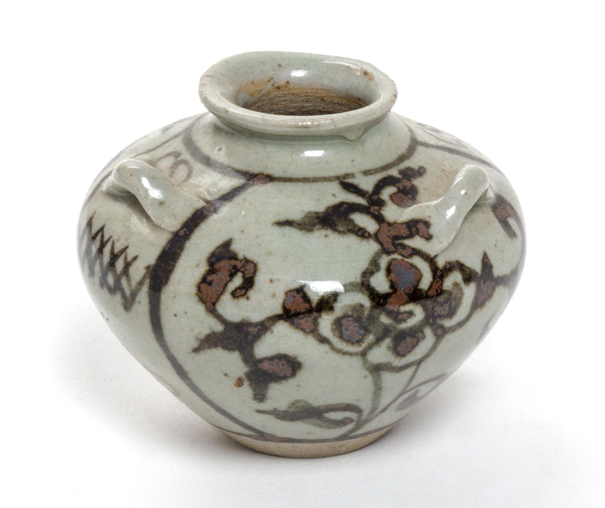 A Small Brown Glazed Pottery Water Dropper Height 2 1/4 inches.