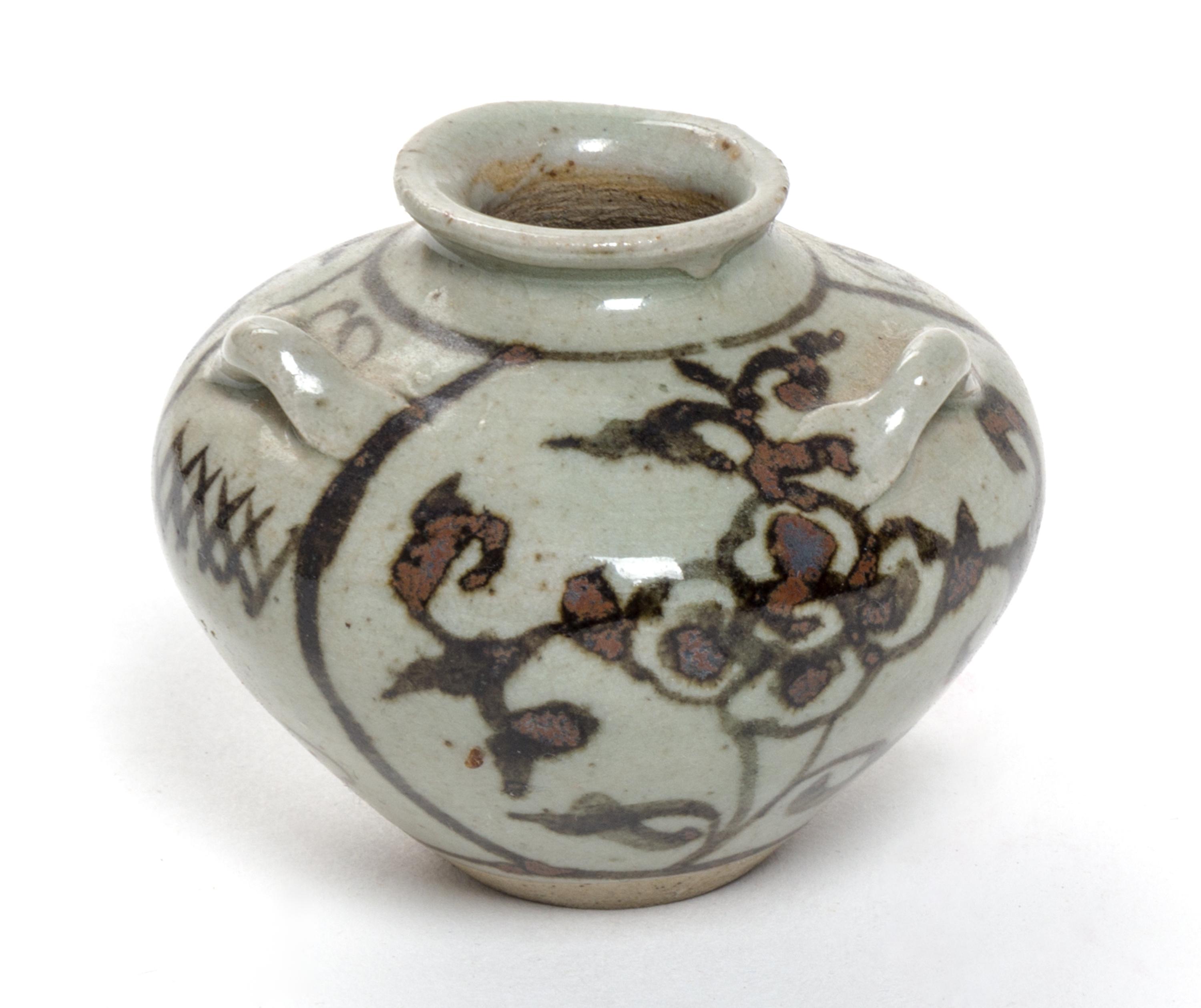 A Small Brown Glazed Pottery Water Dropper Height 2 1/4 inches.