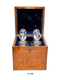 An English Oak Cased Cut Glass Decanter Set
