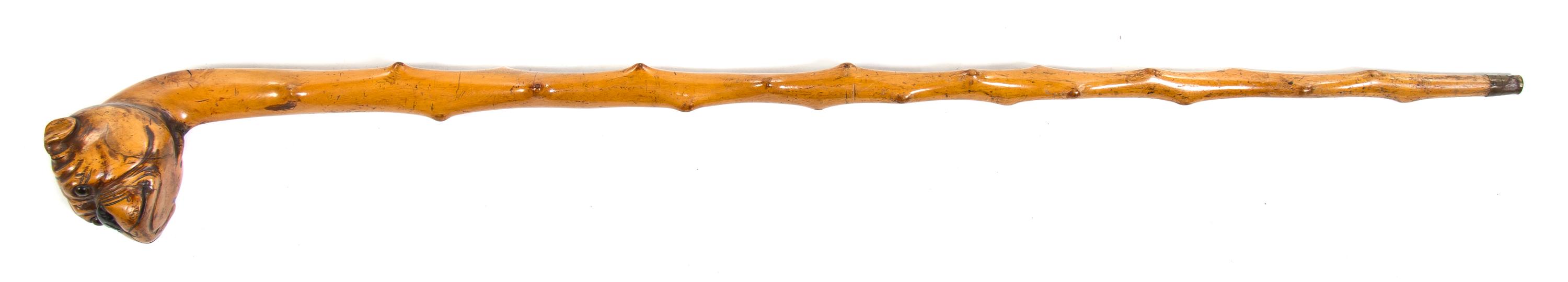 A Carved Fruitwood Cane, Height overall 36 x width of handle 4 1/2 inches.
