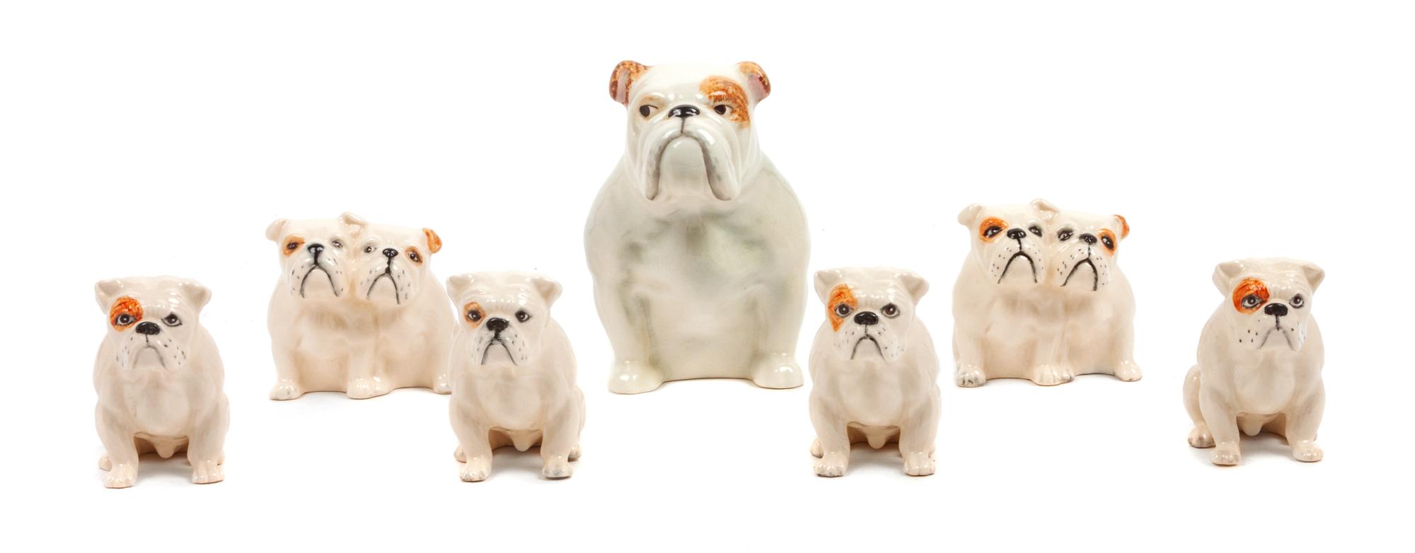 A Group of Seven Beswick Porcelain Bulldogs Height of tallest 4 inches.