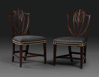 A Pair of Federal Carved Mahogany Shield-Back Dining Chairs