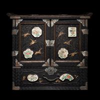 A Japanese Porcelain and Metal Inset Wood Chest