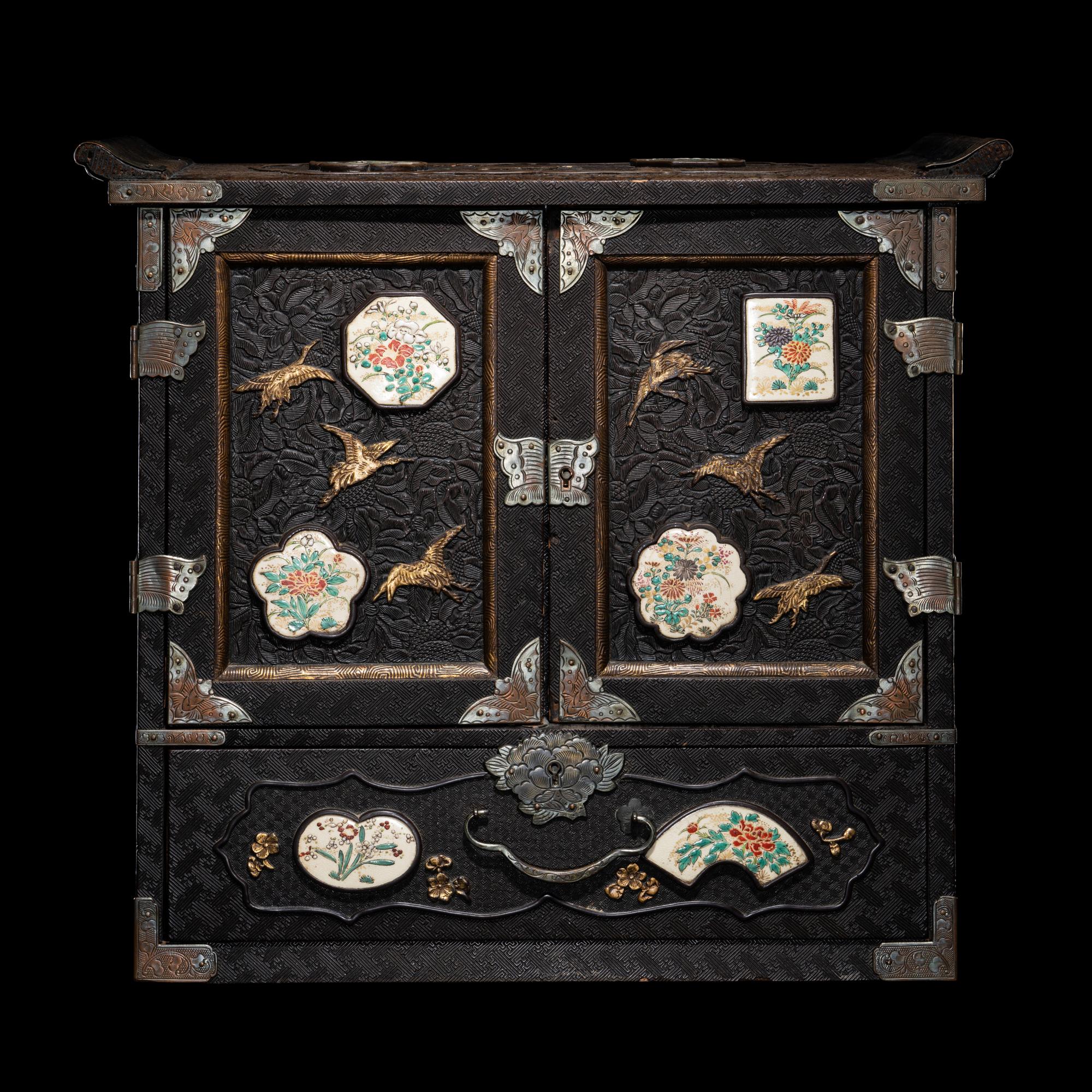 A Japanese Porcelain and Metal Inset Wood Chest