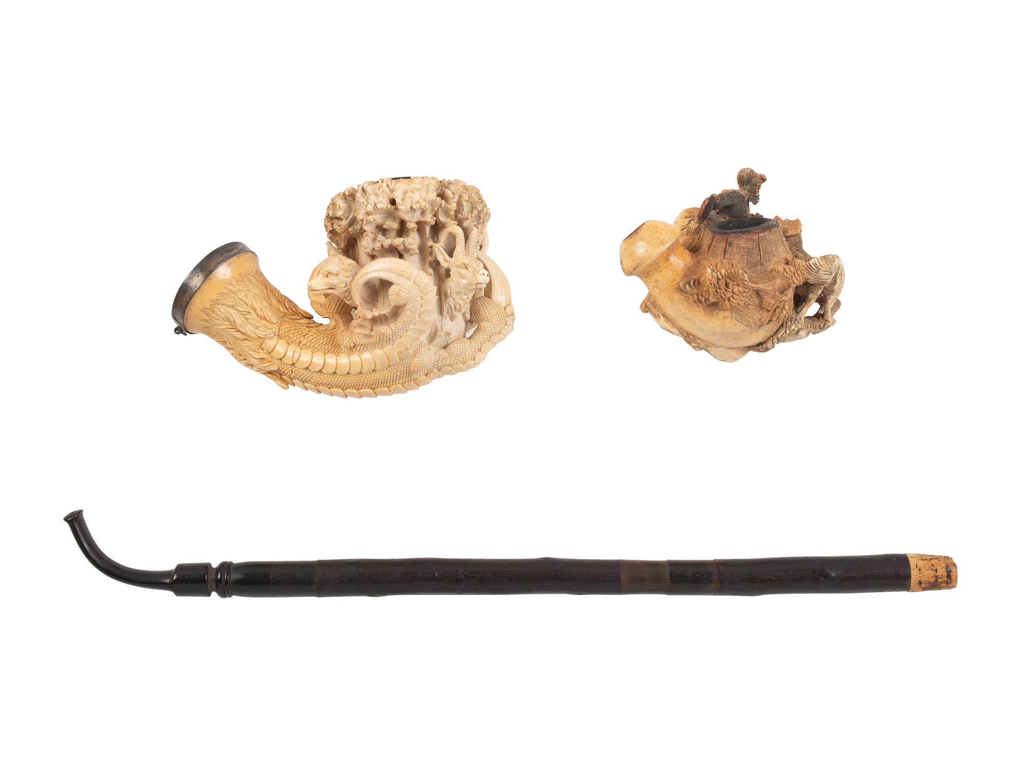 [AMERICANA - PIPES]. 2 ornately carved meerschaum pipes, each featuring animal motifs.