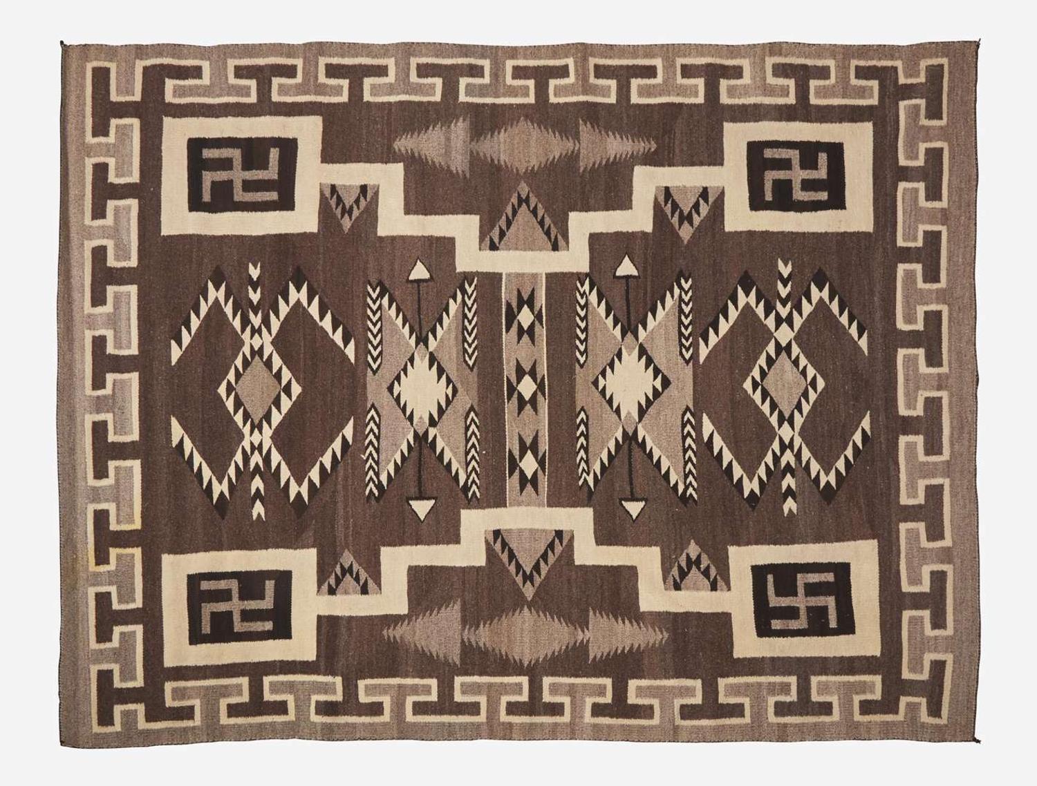 A large Navajo woven rug with whirling logs, early 20th century