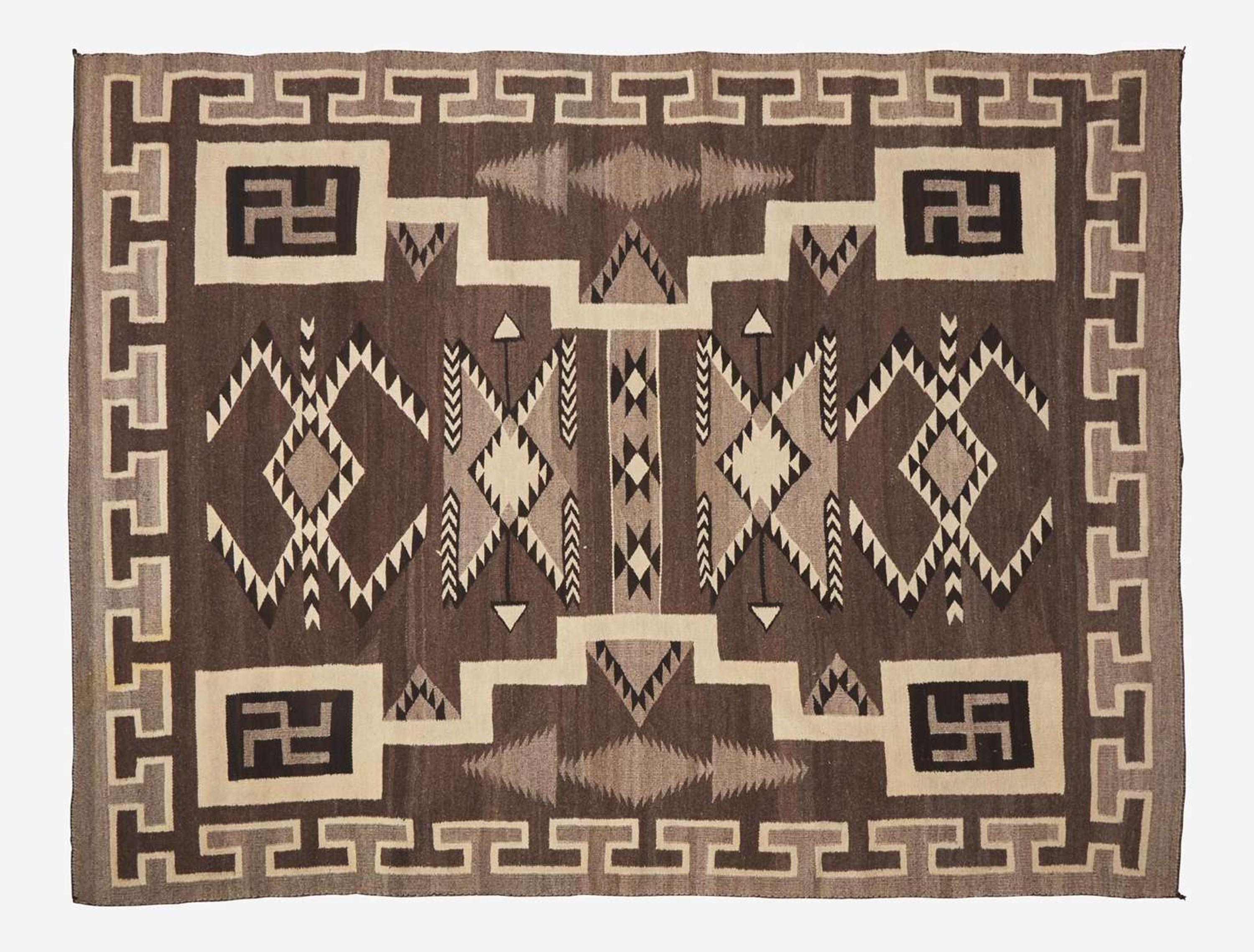 A large Navajo woven rug with whirling logs, early 20th century
