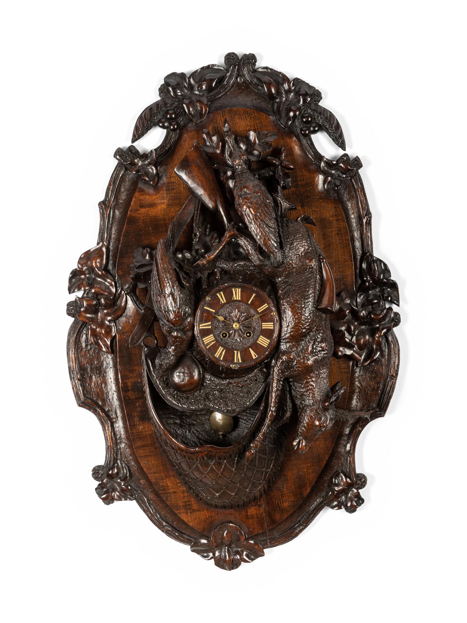 A Swiss Black Forest Carved Walnut Clock