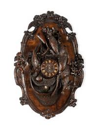 A Swiss Black Forest Carved Walnut Clock