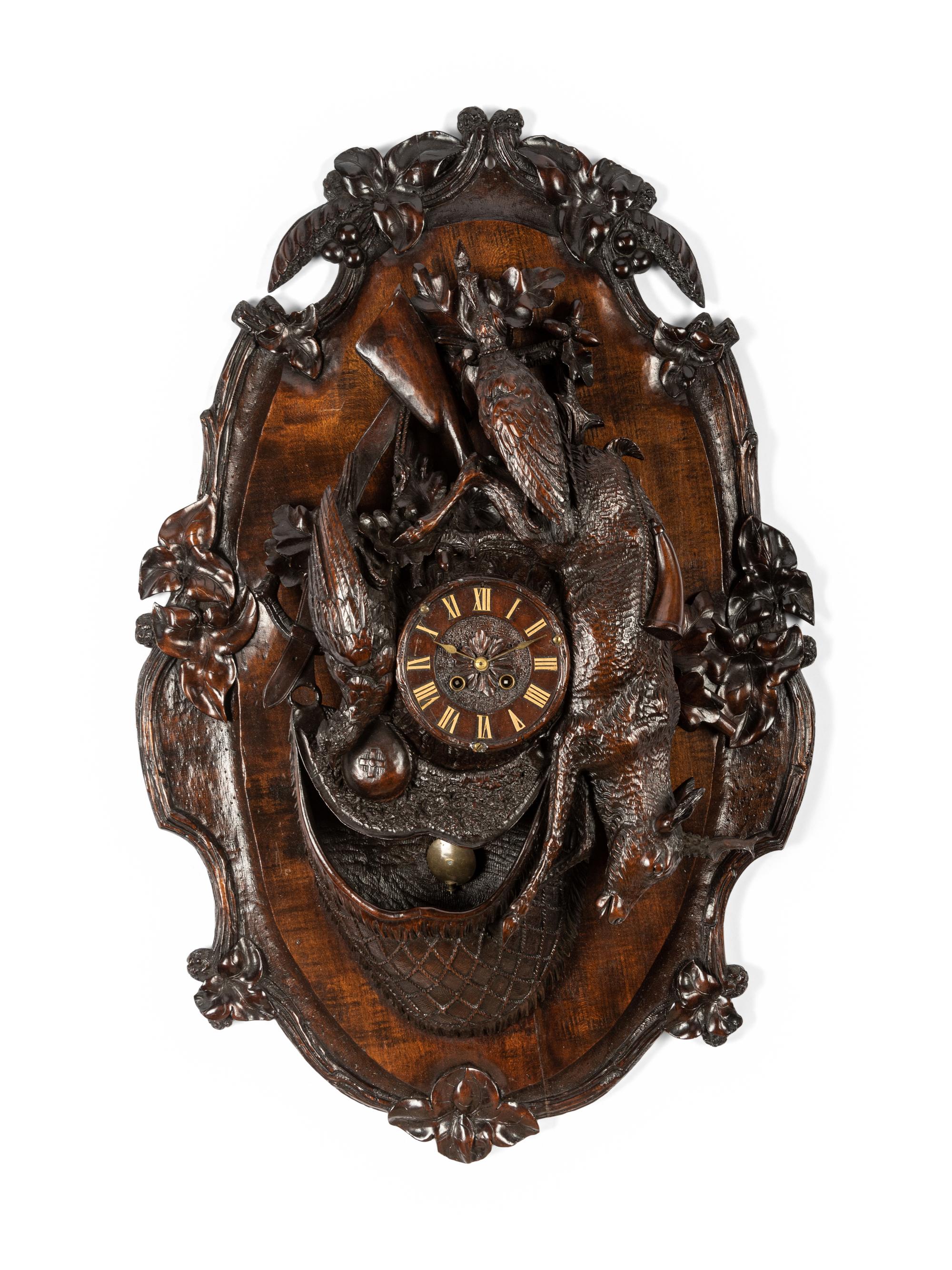 A Swiss Black Forest Carved Walnut Clock