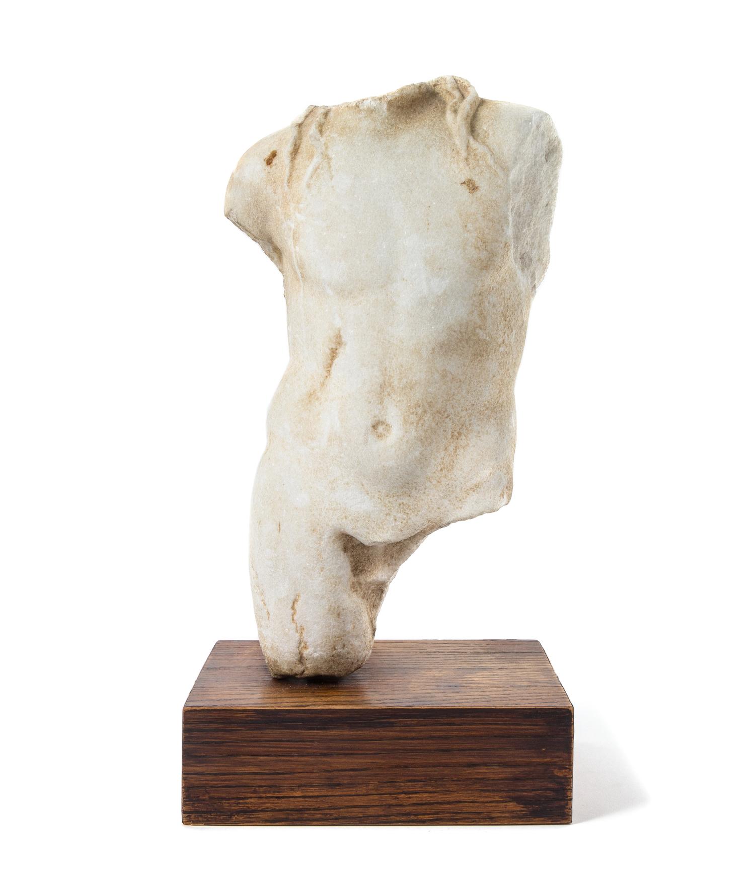 A Roman Marble Torso of a Deity Height of torso 15 3/8 inches. — CIRCA 1ST-2ND CENTURY C.E.