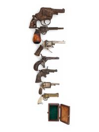 A Group of Eight Miniature Firearms Related Accoutrements