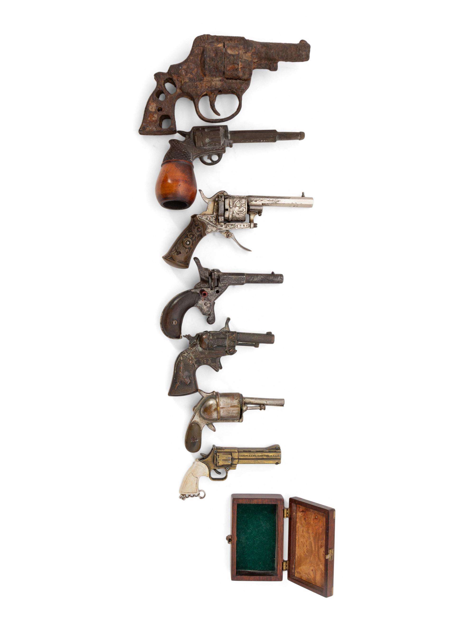A Group of Eight Miniature Firearms Related Accoutrements