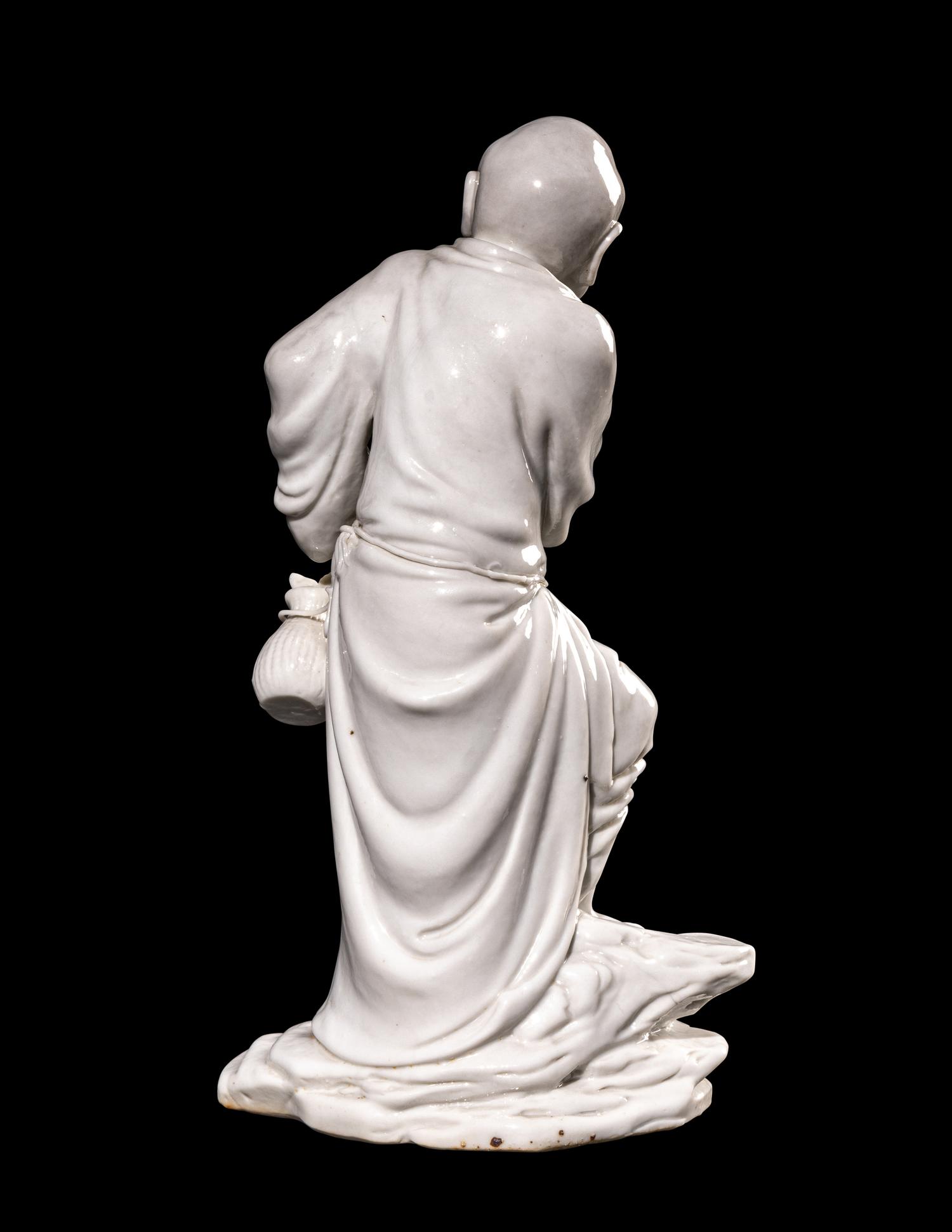 A Chinese Blanc-de-Chine Porcelain Figure of a Fisherman
