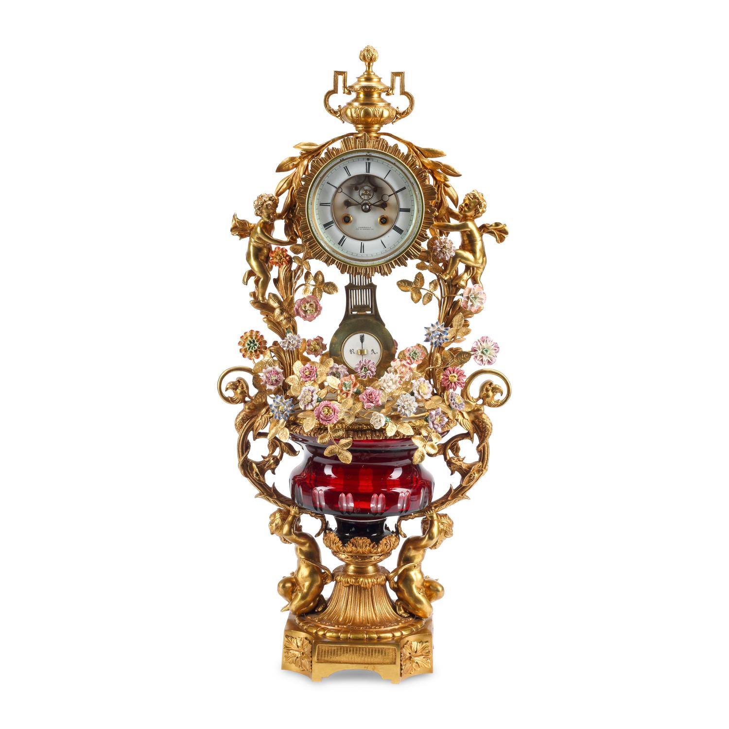 A Louis XV Style Red Cut Glass, Gilt Bronze and Porcelain Clock