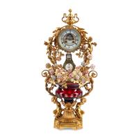 A Louis XV Style Red Cut Glass, Gilt Bronze and Porcelain Clock