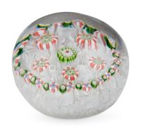 A Spaced Concentric Millefiori Over Upset Muslin Glass Paperweight