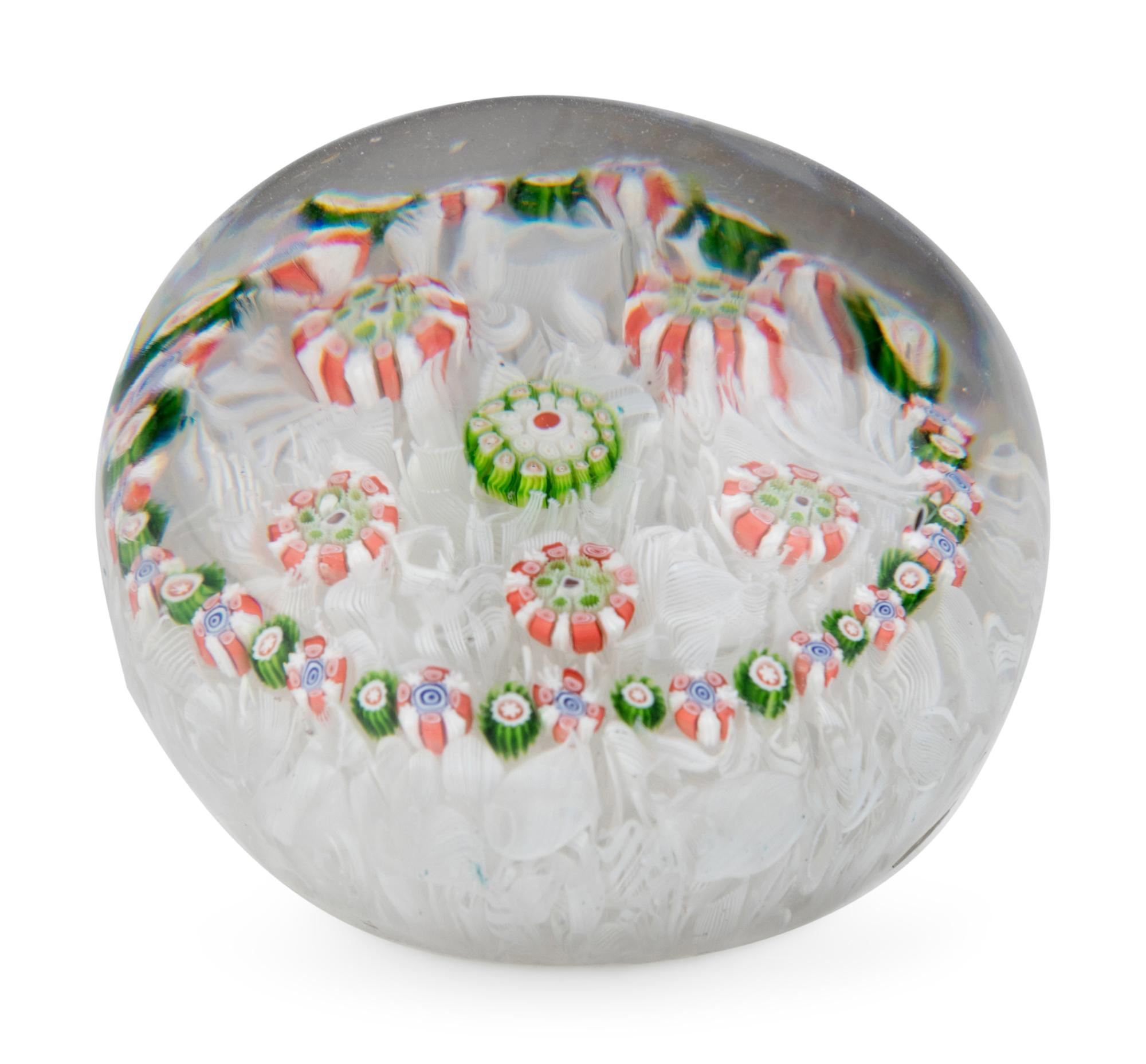A Spaced Concentric Millefiori Over Upset Muslin Glass Paperweight