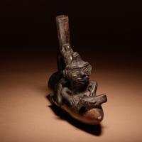A Moche Stirrup Vessel of Man on Reed Boat with Fish