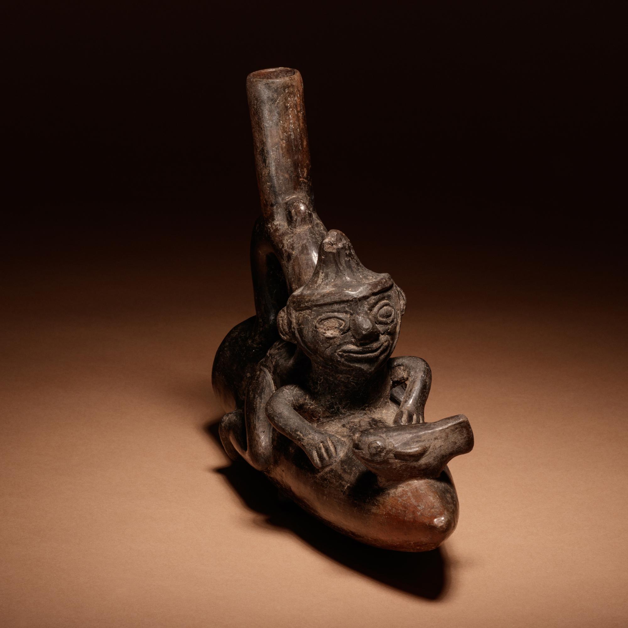 A Moche Stirrup Vessel of Man on Reed Boat with Fish