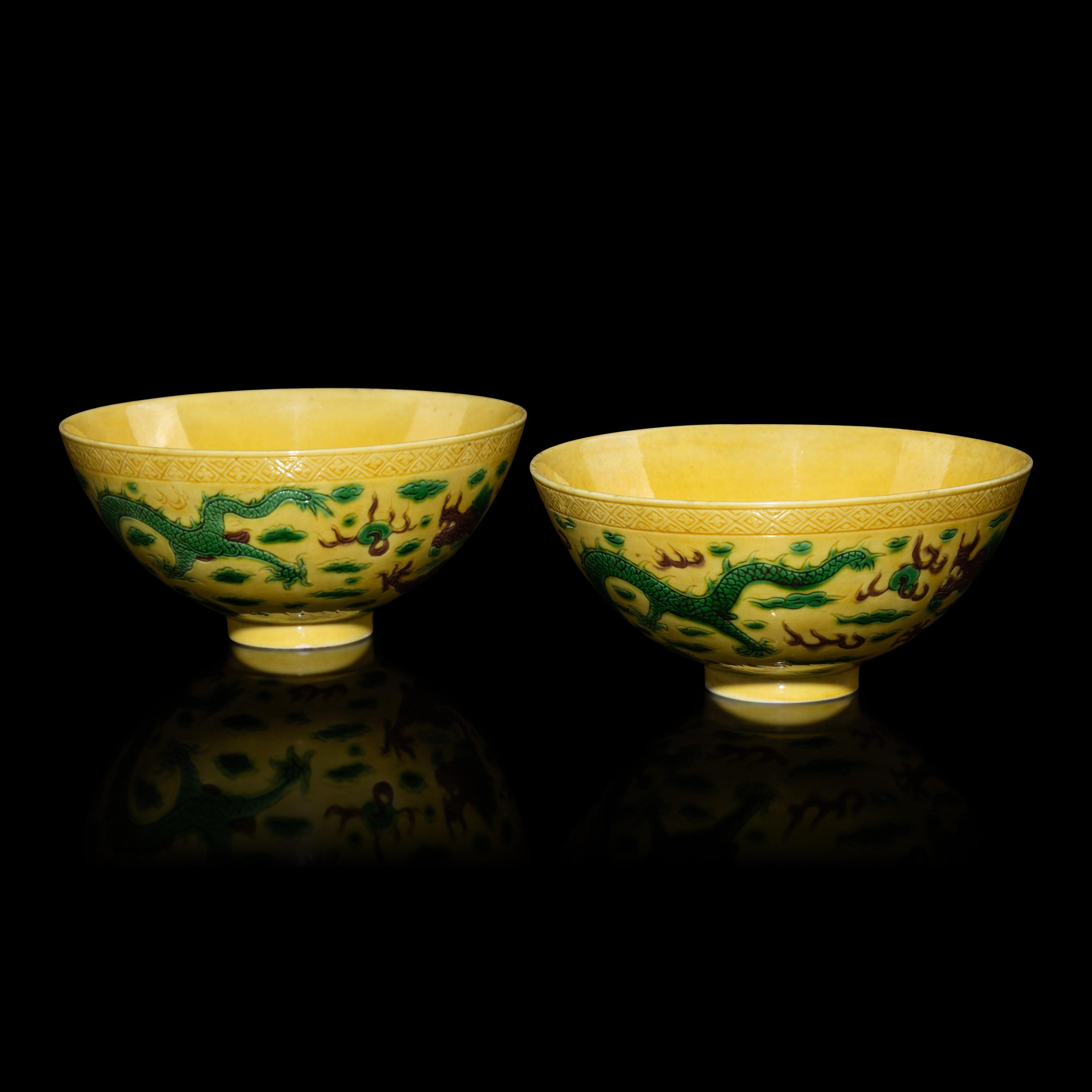 A Pair of Chinese Yellow-Ground Green and Aubergine-Enameled Porcelain 'Dragon' Bowls — 黃地素三彩龍紋碗一對