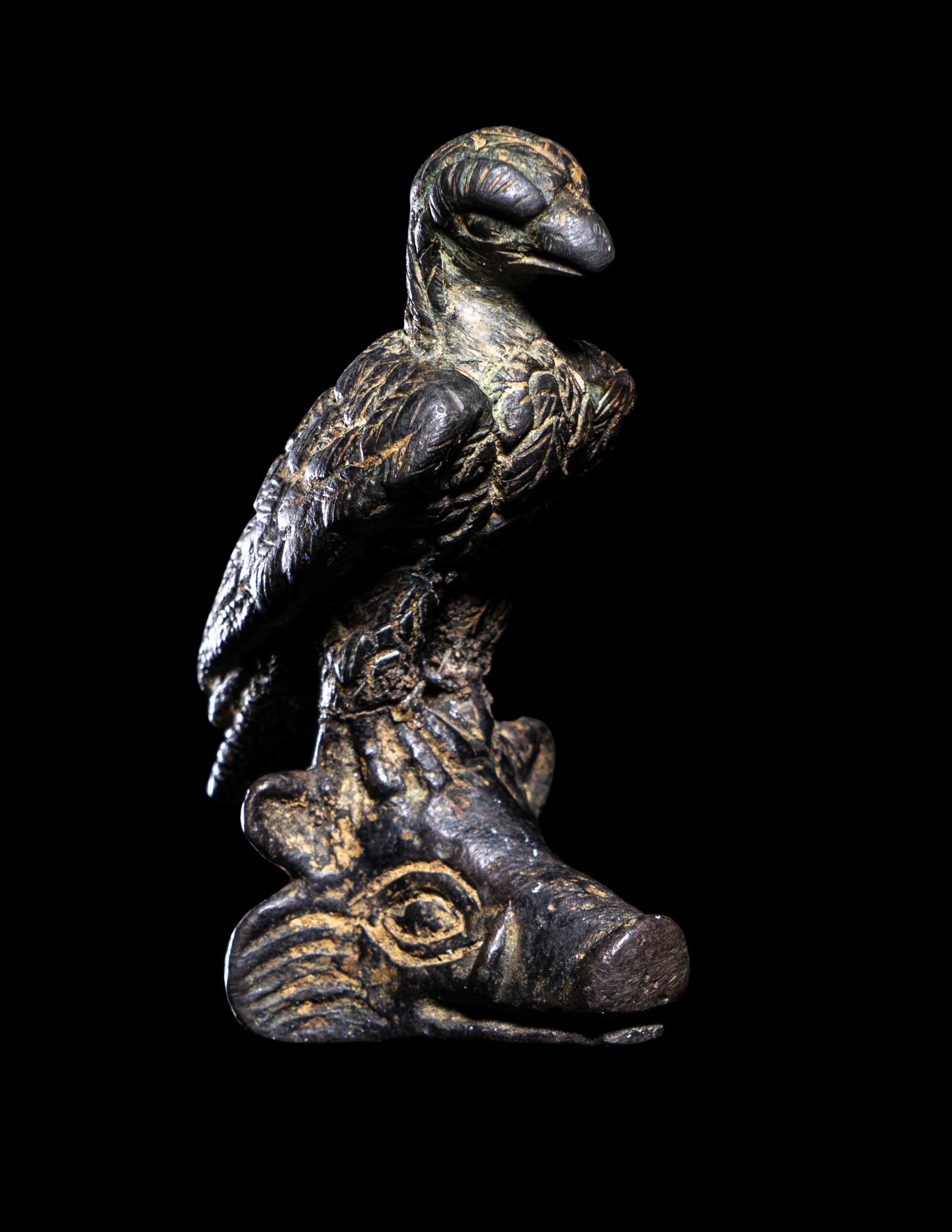 A Roman Bronze Eagle Perched on a Boar's Head