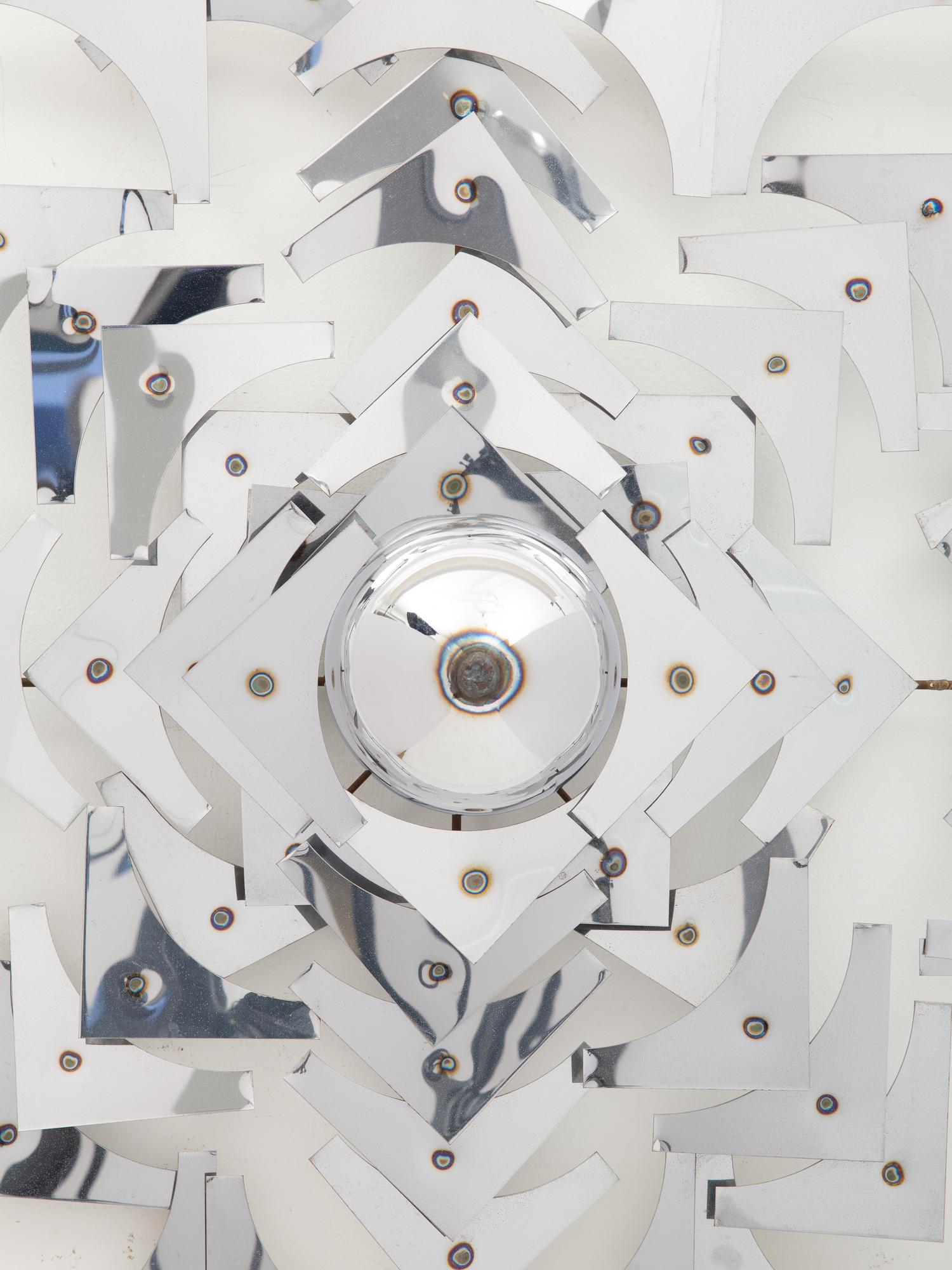 A Geometric Polished Steel Wall Sculpture
