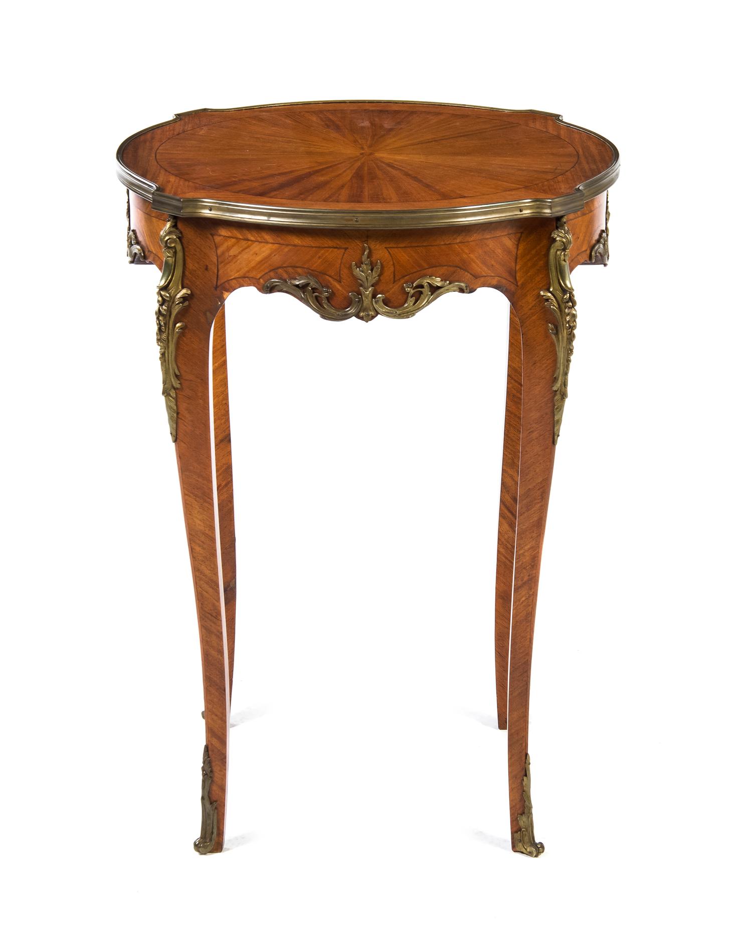 A Louis XV/XVI Transitional Style Gilt Metal Mounted Fruitwood Occasional Table, Height 30 x diameter 22 inches.