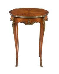 A Louis XV/XVI Transitional Style Gilt Metal Mounted Fruitwood Occasional Table, Height 30 x diameter 22 inches.