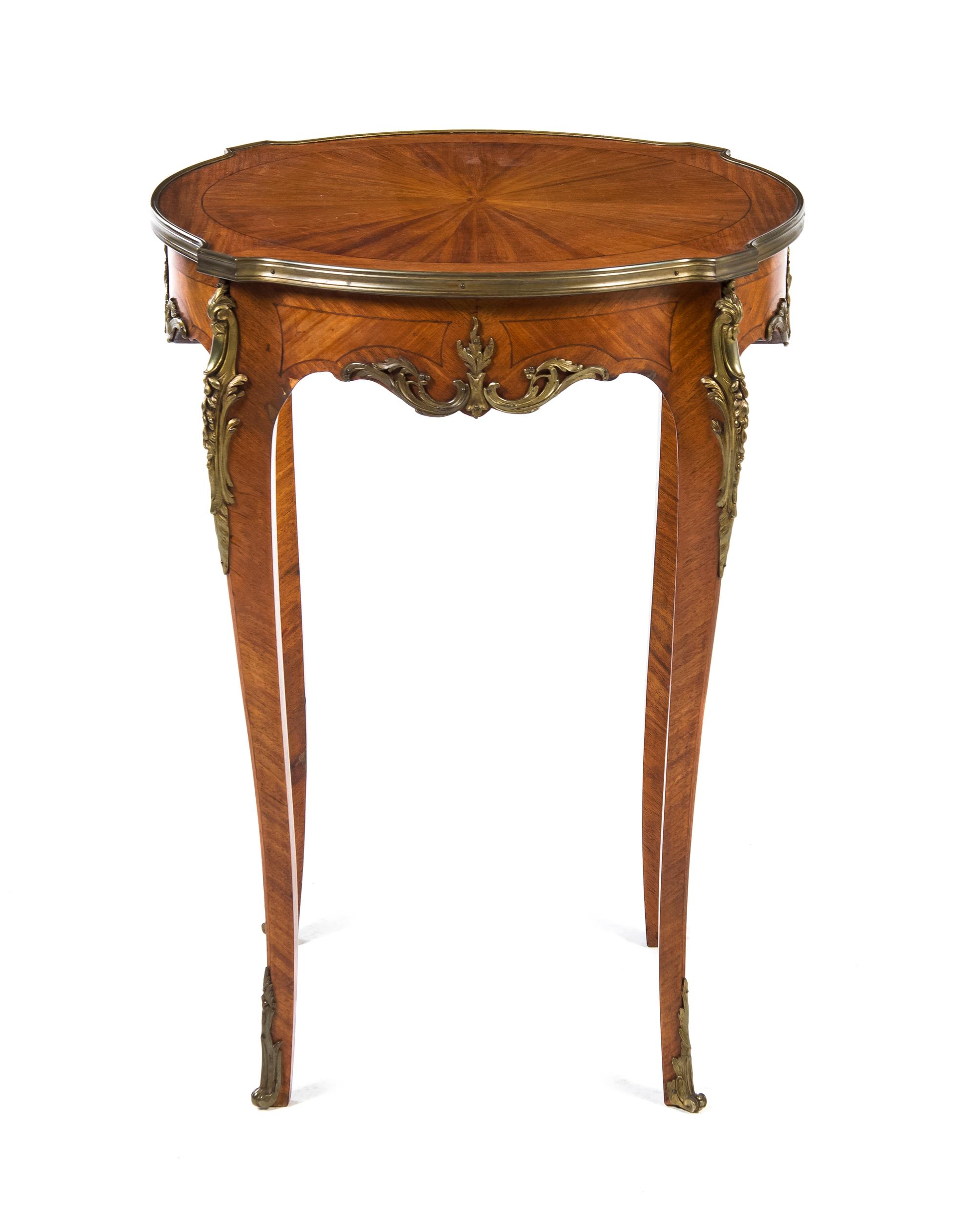 A Louis XV/XVI Transitional Style Gilt Metal Mounted Fruitwood Occasional Table, Height 30 x diameter 22 inches.