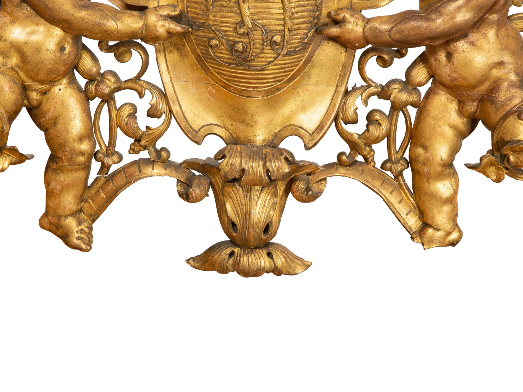 A Continental Carved Giltwood Cherub Wall Plaque